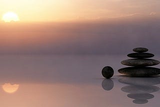 Stones balancing on the beach to demonstrate that everything is in a balanced state