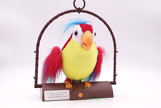A brightly colored toy parrot with red, yellow, and blue feathers perched on a brown swing.