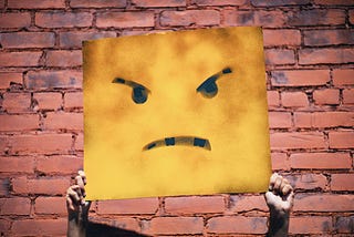 Photo of a sign showing an angry face. Source: Andre Hunter, Unsplash