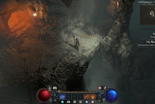 Diablo IV’s customizable player character stands in a moody cave.