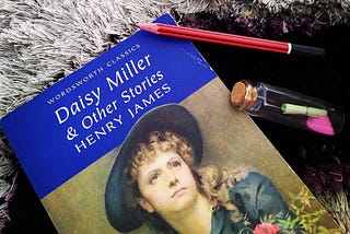 A book by Henry James titled Daisy Miller & other short stories along with a pencil and a message bottle.
