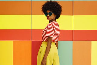 girl in front of a wall of colors.