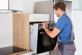 Handyman in Mississauga installing kitchen appliance