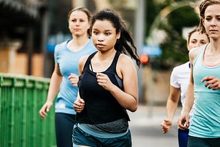 A group of females running demonstrading that they are being active in their workout. Photo by Healthline,