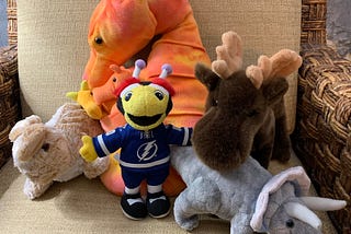 A lop-eared, tan bunny; an orange seahorse with three babies in its pouch, Thunderbug in his Lighting jersey, a moose, and a grey-and-blue triceratops.