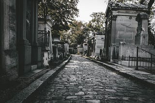 Cobblestone street through a cemetery