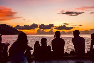 A group of friends watching the sunset.