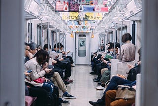 Japanese people being quite and respectful on a train expressing omotenashi.