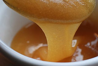 Honey dripping from a spoon