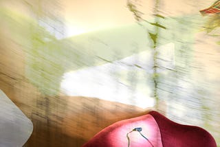 Image of a red chair with dreamlike, smeared background