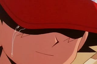 Ash, the original main character from the Pokemon series, sheds a single tear, his eyes hidden behind his red cap and a slight smile on his face