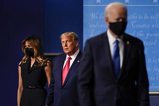 Melania Trump and President Trump remain onstage as Joe Biden leaves at the closing of the last presidential debate.