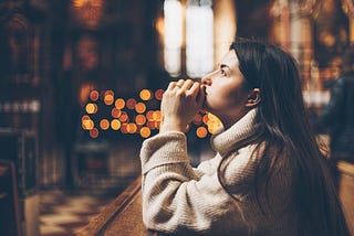 Woman deep in prayer before making her confession. Adobe stock photo by Ananass