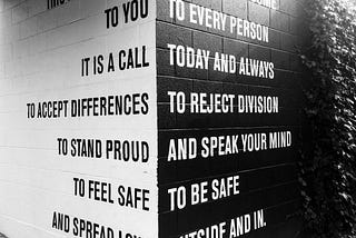 Black and white wall with words.