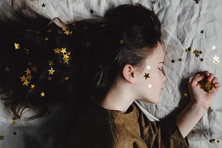 A young girl with gold stars in her hair.
