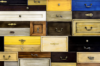 An image showing multicoloured closed drawers