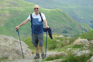 An older man out hiking in the mountains