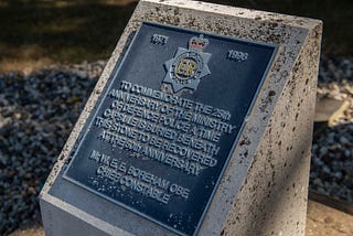 A concrete plinth with the MDP crest and words engraved regarding the time capsule being buried for the Force’s 25th anniversary, and dug up the 50th anniversary