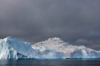 Storm clouds hover above giant icebergs at the UNESCO World Heritage Site in Ilulissat, Greenland.