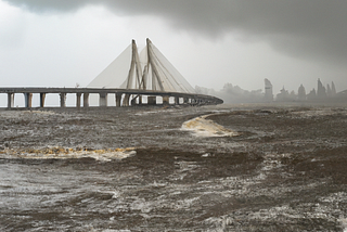 Mumbai Bandra-Worli sea link, outcast weather, big waves on the coast, gloomy sky, realistic photo. Generate by Dall-E.