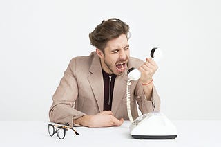Angry customer yelling at phone
