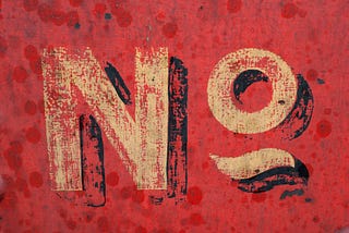 A red grundy background wall with the word “No” hand-painted on it