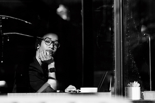 Isis-Rae Goulbourne looks out the window of a cafe