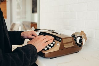 Someone typing on a typewriter