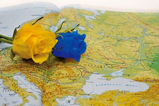 yellow and blue roses resting on a map of Ukraine.
