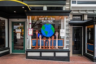 A shop front saying that we are all in this together