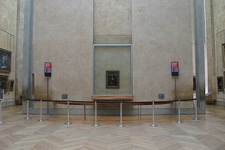 A gallery room with paintings without any people.