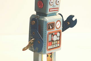 A vintage robot with a wrench for an arm and a windup key for operation