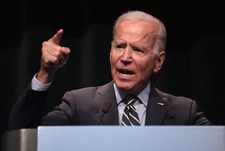 President Joe Biden Speaking in front of a lectern,