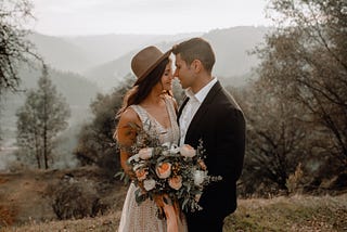 A bride and a groom outdoors.