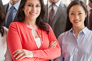 Diverse group of business professionals standing together and facing the camera for a group shot.