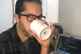 Michael Newman drinking life-sustaining coffee.