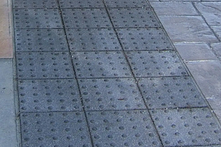 What are the advantages of truncated dome pavers for pedestrians?