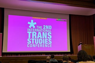 A bright pink slide “The 2nd International Trans Studies Conference”