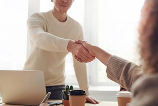 People shaking hands on accepting a job offer.