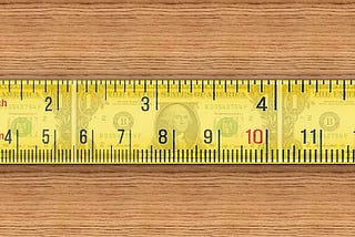 A tape measure that stretches out and appears to measure dollars