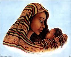 A woman looks lovingly at her baby while both are wrapped in a blanket.