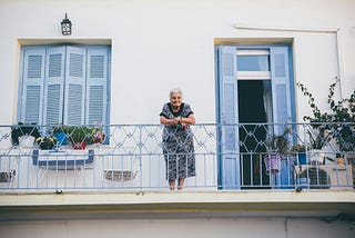 grandmother on balcony of greek house