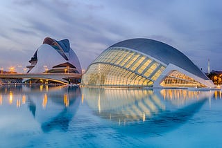 Picture of a modernistic looking building in Valencia, Spain, surrounded by water.