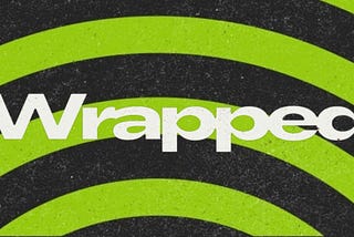 The word Wrapped over a circular background in Spotify’s green and black colors.
