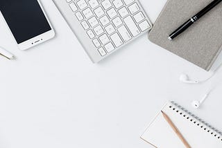 Desk with electronic devices and notebooks