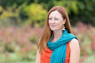 Photo of author walking through blueberry bushes in the fall