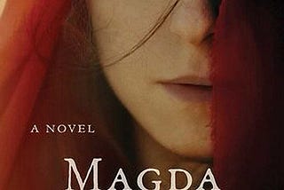 A beautiful young woman with half her face covered by a red shawl.
