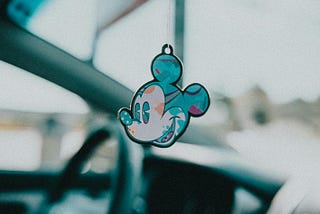 A Mickey Mouse pendant against sky.