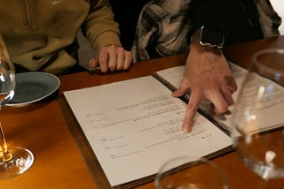 image of a finger pointing to a menu