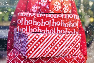 Woman holds stack of packages in red holiday wrapping